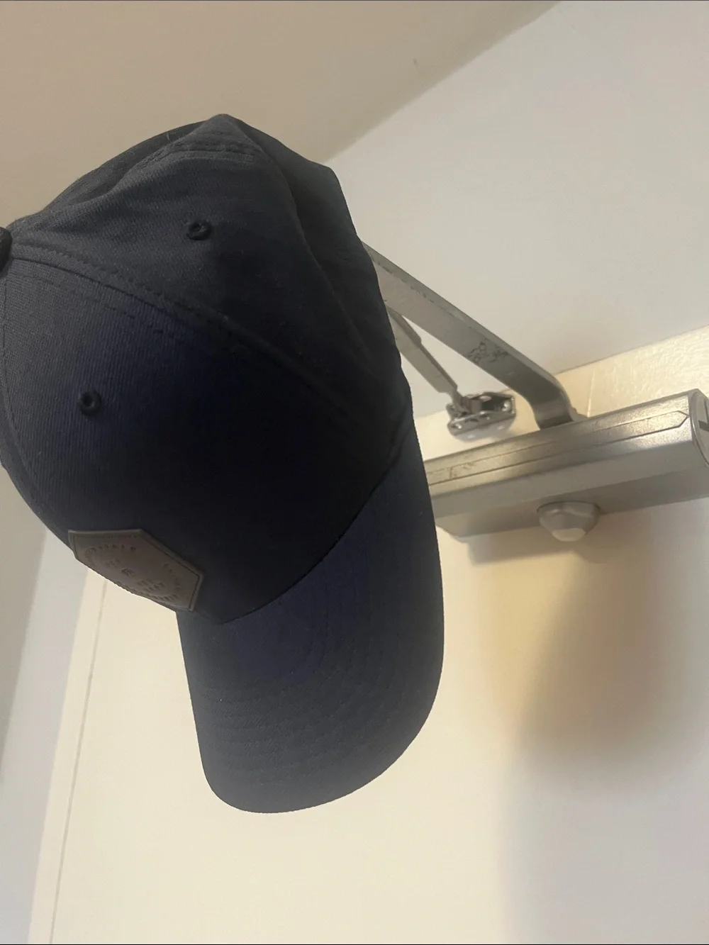 Travis Mathew Navy Blue Baseball Cap with Brown Hex Patch